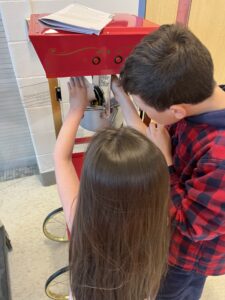 A boy and girl doing a STEM activity