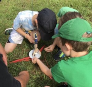 3 children doing a STEM activity