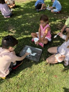 Kids sitting outside in the grass